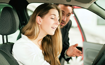 Woman buying car from salesperson